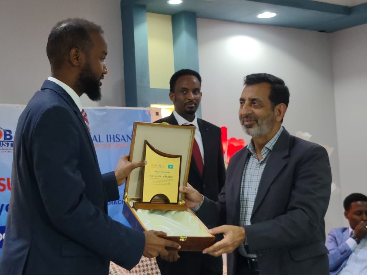Dr intzar hussain giving shield to the student of master degree course somaliland